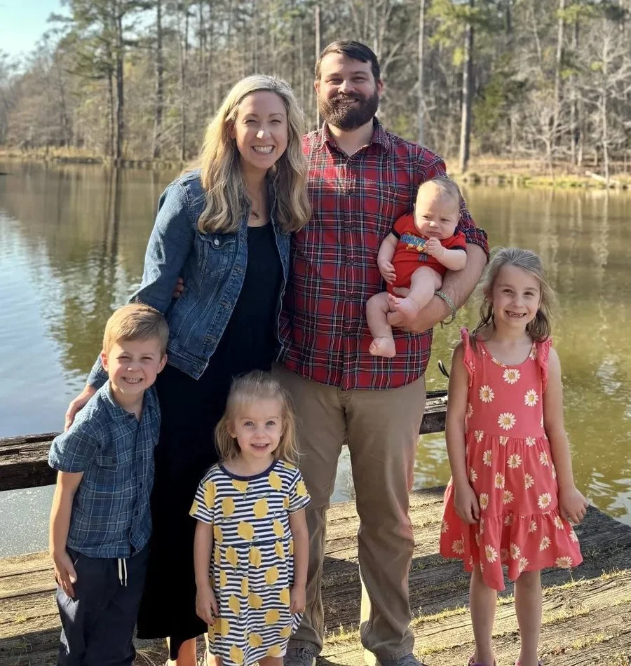 Nathan with his family outdoors
